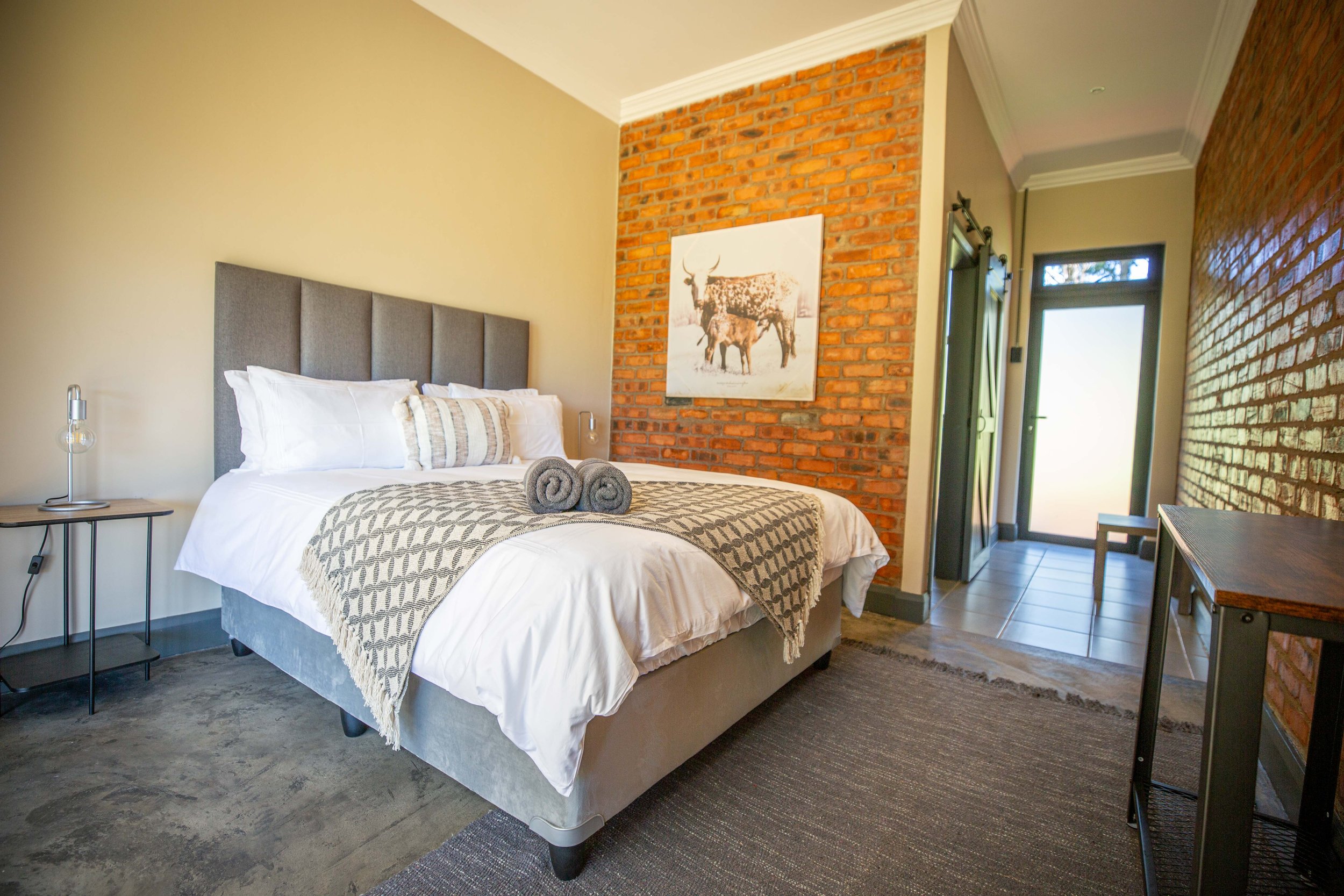 Queen bed with Nguni cattle artwork in Annex Room 6