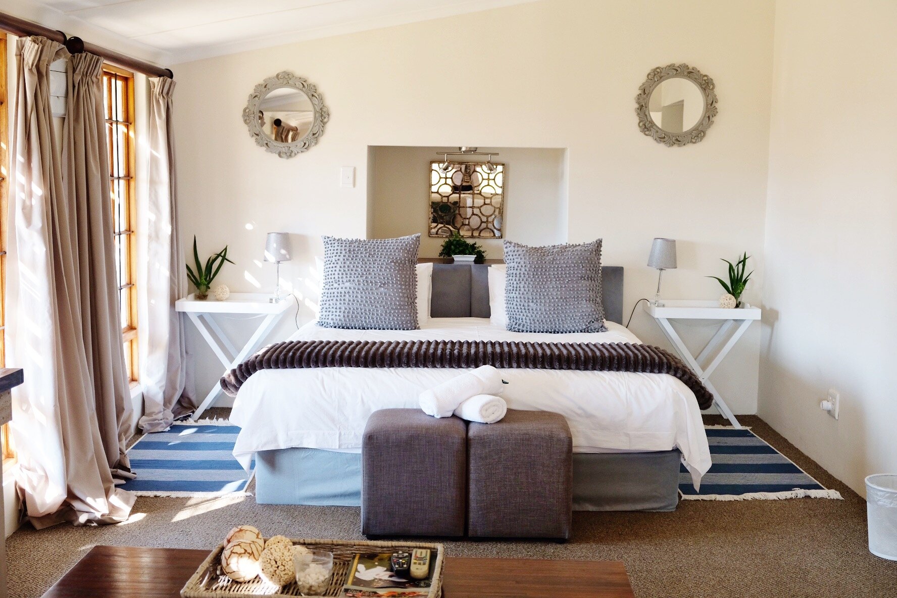 King size bed with grey cushions in Crane Cottage