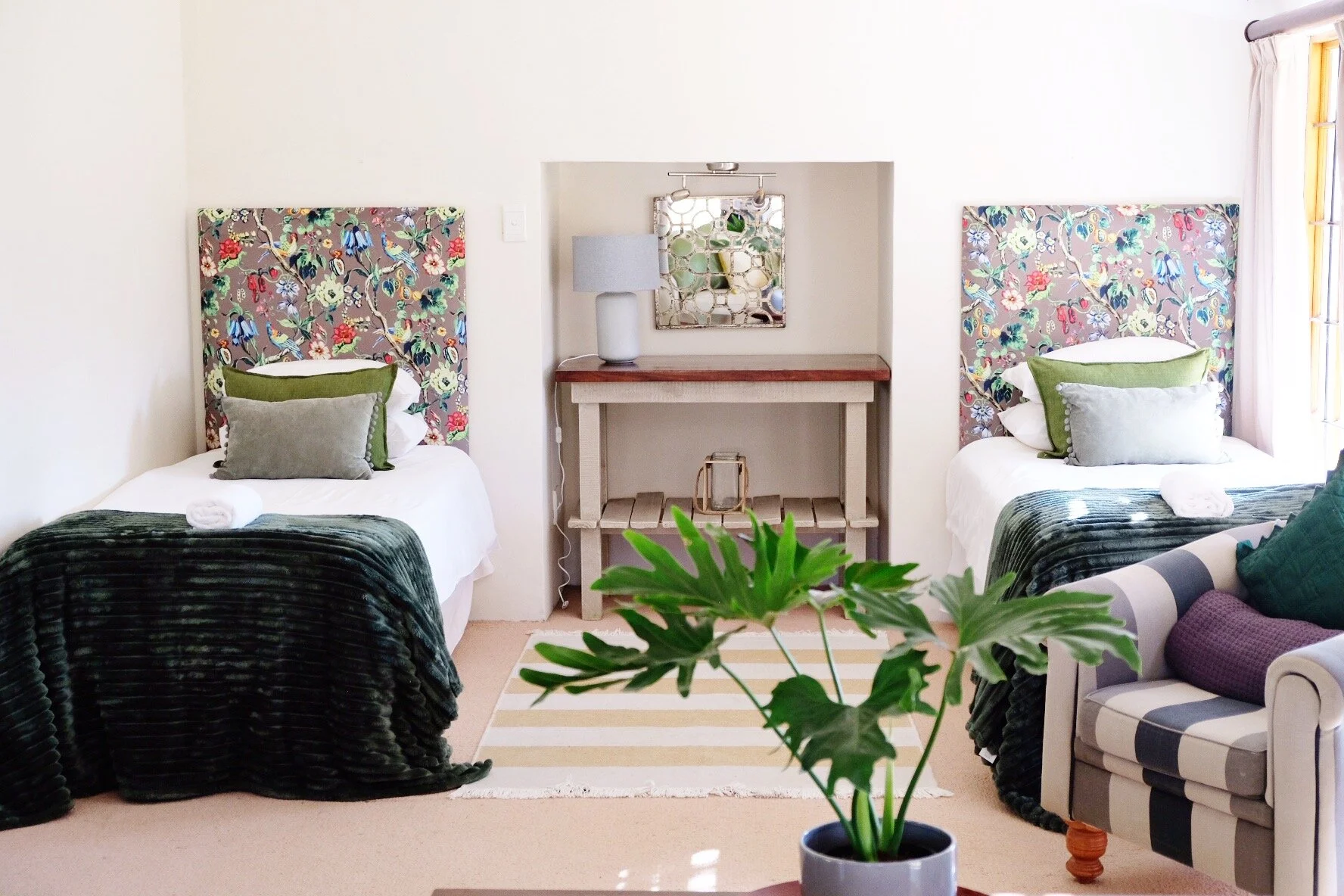 Twin beds with floral headboards in Heron Cottage